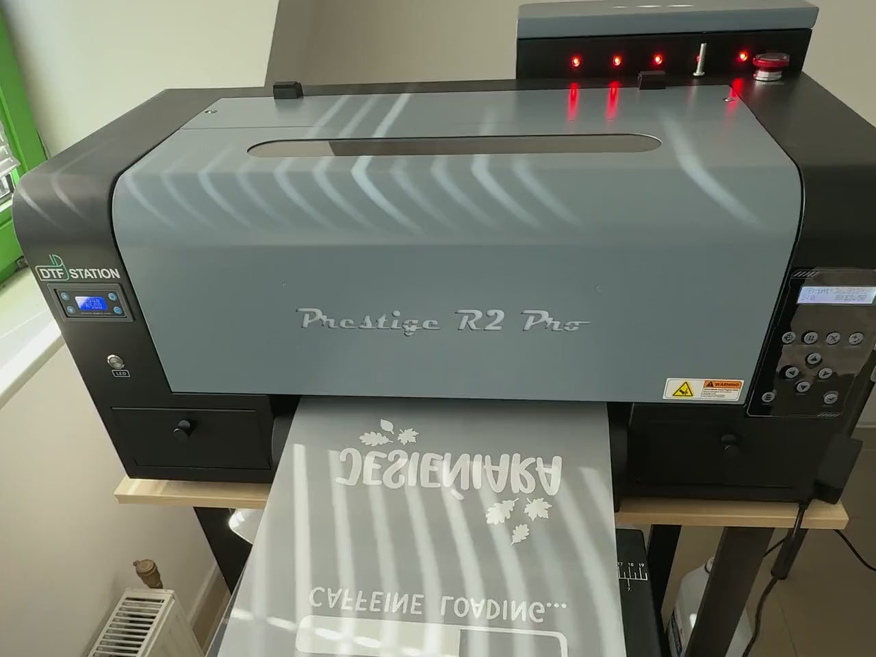 Film z produkcji: drukarka DTF, wydruk logo na folii, folia na rolce i na koszulce, prasa, zdejmowanie folii, druk DTG i haft logo